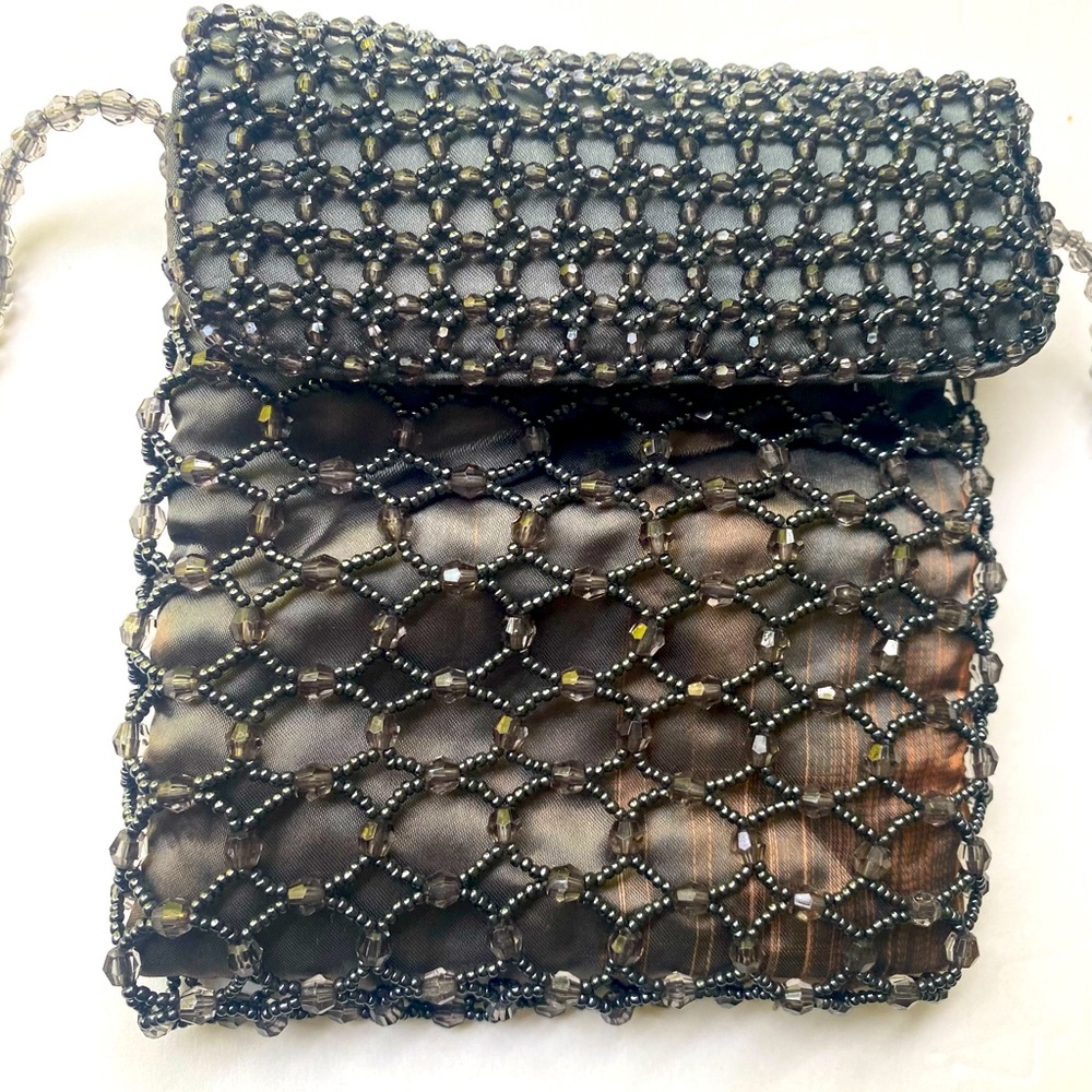 Handmade traditional bag with Chaquiras stones, made with satin fabric.